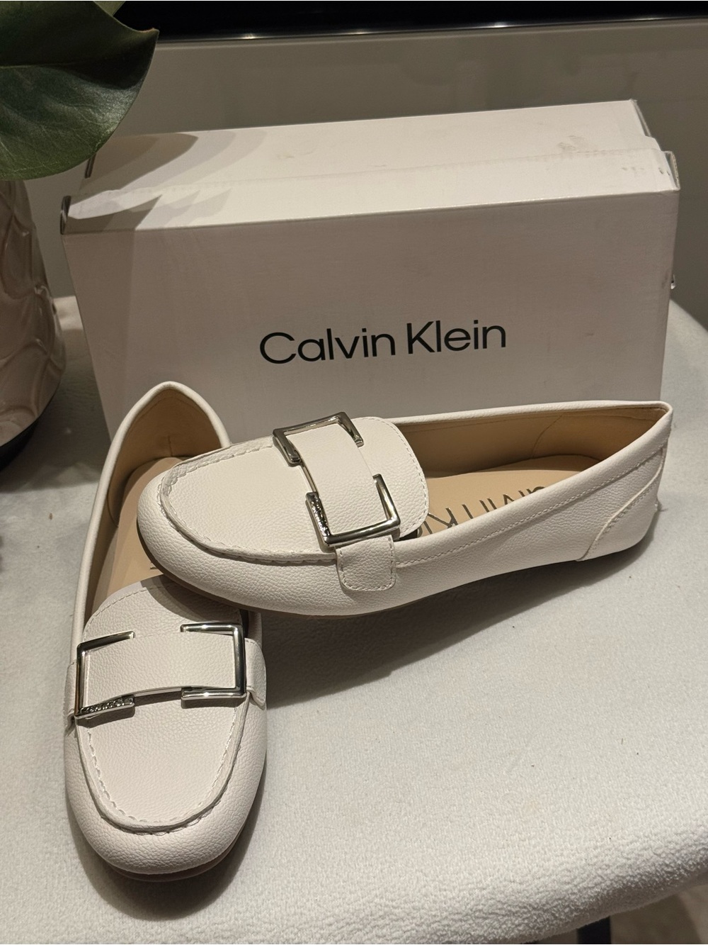 Calvin Klein Lydia Loafer in white, highlighted by a metallic rectangular buckle